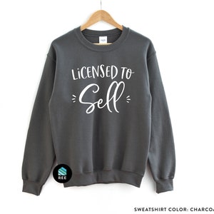 May include: Charcoal gray sweatshirt with the text "Licensed to Sell" in white lettering.
