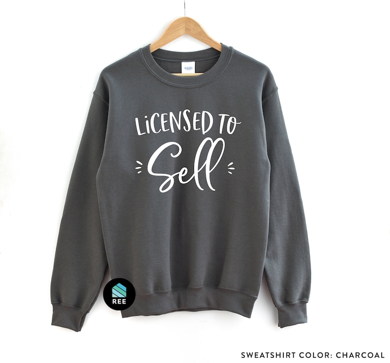 May include: Charcoal gray sweatshirt with the text "Licensed to Sell" in white lettering.