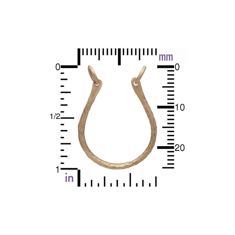 May include: A single, open-hoop earring in a light, textured metal. The earring is approximately 1 inch in diameter. The design is a simple, curved shape with a small loop at the top for attachment.