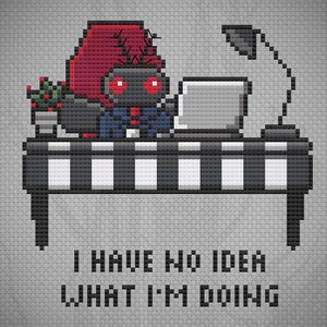 May include: A cross-stitch pattern featuring a pixelated character with red eyes and a red hood sitting at a black and white striped desk with a laptop and lamp. The text reads: BYMEGC and I HAVE NO IDEA WHAT I'M DOING in black pixelated font.