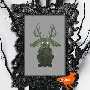 May include: Cross-stitch pattern of a green, deer-like creature with large eyes and antlers. The creature is sitting on a gray background. The pattern is framed in a black ornate frame.