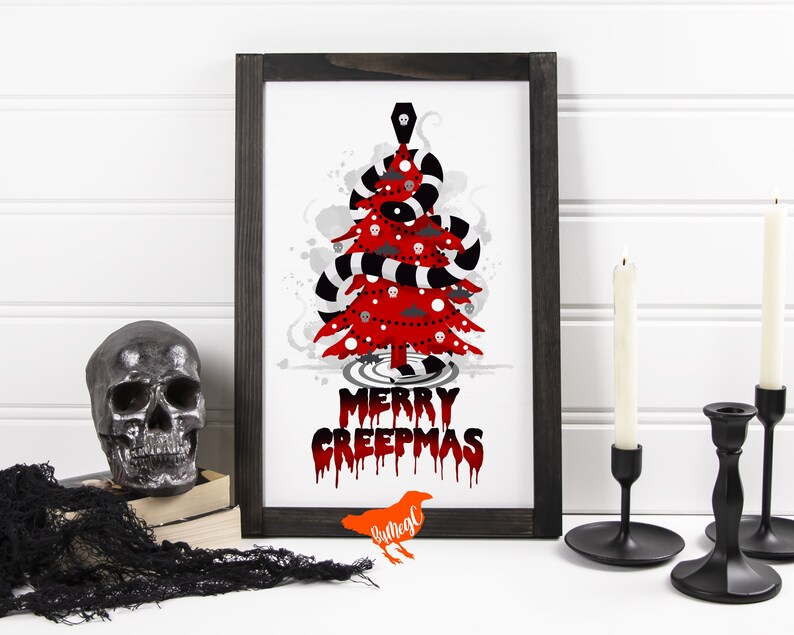 May include: A framed print of a red and black Christmas tree with the text "Merry Creepmas" in dripping red letters. The tree is decorated with skulls, bats, and a coffin. The print is on a white background and has a black frame.