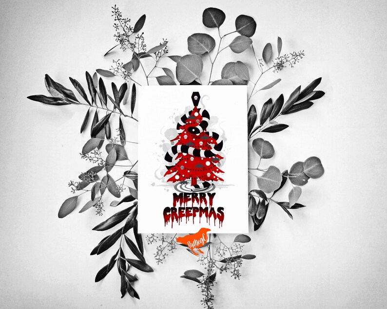 May include: A white card featuring a red and black Christmas tree design. The tree is decorated with candy canes, eyeballs, and a skull. The text "Merry Creepmas" is written in red dripping letters below the tree.