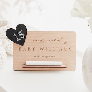 May include: A wooden countdown block with a chalkboard heart that says "15" and the text "weeks until BABY WILLIAMS arrives".