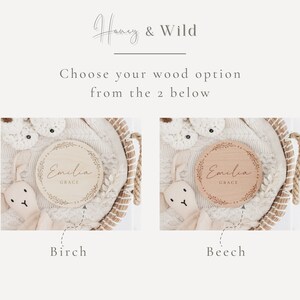 May include: Two wooden baby name plaques with a floral wreath design. The plaque on the left is on a birch background and the plaque on the right is on a beech background. Both plaques have the name "Emilia Grace" engraved on them.