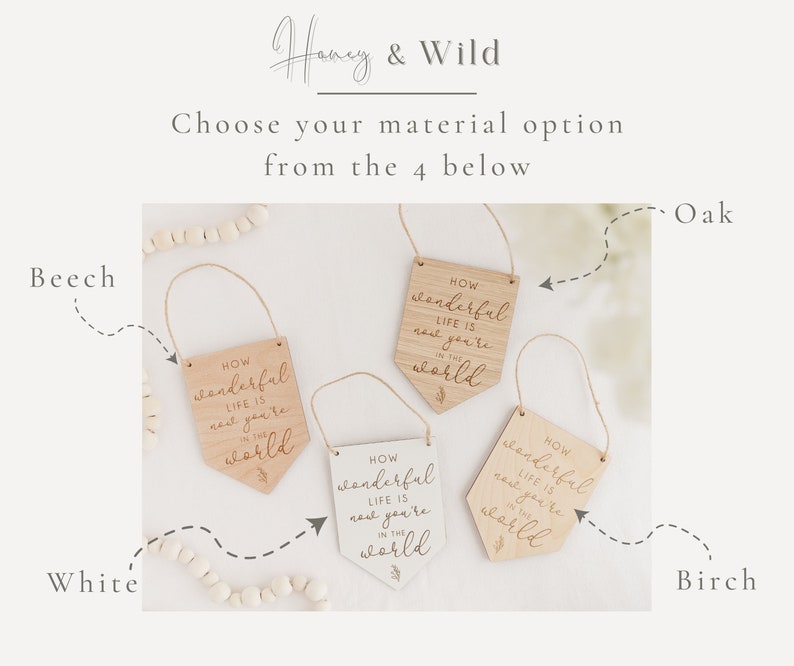May include: Four wooden signs with the text "How wonderful life is now you're in the world" in different wood finishes: beech, white, oak, and birch.