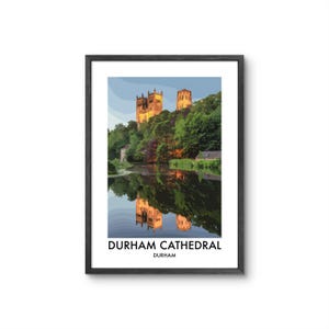 May include: A framed art print featuring a stylised illustration of Durham Cathedral illuminated by golden light, set above a river with a clear reflection. The text DURHAM CATHEDRAL and DURHAM is printed in black at the bottom of the white border.