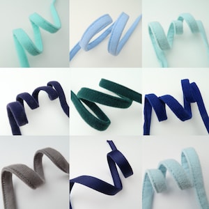 May include: Assortment of nine different colours of soft, fuzzy trim. The trim is approximately 1 inch wide and is available in a variety of colours, including blue, green, grey, and white.