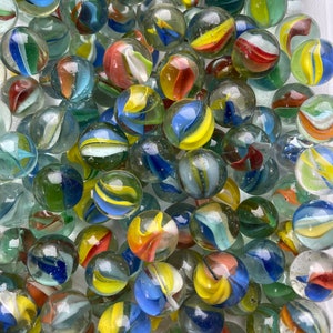 May include: A collection of colorful glass marbles with swirls of blue, yellow, red, and white. The marbles are in a clear plastic container.
