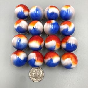 May include: Sixteen vintage marbles with a swirl of red, white, and blue colors. The marbles are arranged in four rows of four. A dime is placed next to the marbles for size comparison.