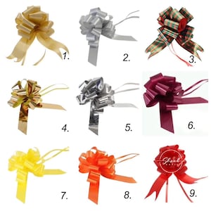 May include: Nine different colours of pull bows for gift wrapping. The bows are made of shiny, curled ribbon and are tied in a simple knot. The colours are gold, silver, red and green plaid, burgundy, yellow, orange, and red.