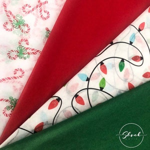 May include: Four sheets of tissue paper with different Christmas patterns. The first sheet is white with red and green candy canes. The second sheet is red. The third sheet is white with a black string of Christmas lights with red, blue, and green bulbs. The fourth sheet is green.