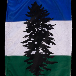 May include: A blue, white, and green neck gaiter with a black silhouette of a coniferous tree. The tree is centered on the gaiter and is surrounded by a topographic map pattern.