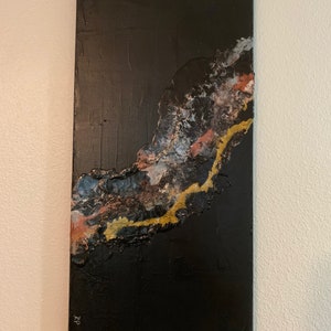 May include: Abstract painting on canvas with a black background and a textured, flowing design in shades of gold, white, and pink.