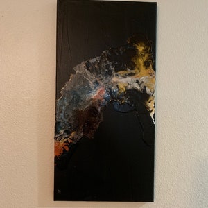 May include: Abstract art painting on canvas with a black background and a large, flowing, multi-colored design in the center.