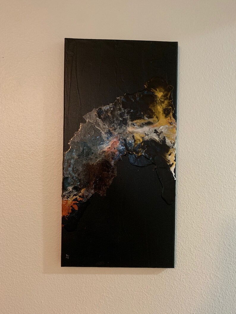 May include: Abstract art painting on canvas with a black background and a large, flowing, multi-colored design in the center.