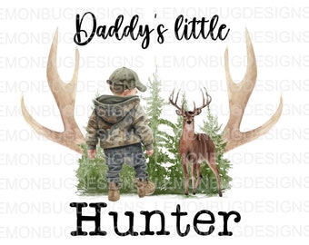 May include: A watercolor illustration of a young boy dressed in camouflage clothing standing in front of a deer and a pair of antlers. The text "Daddy's little Hunter" is written above the boy.