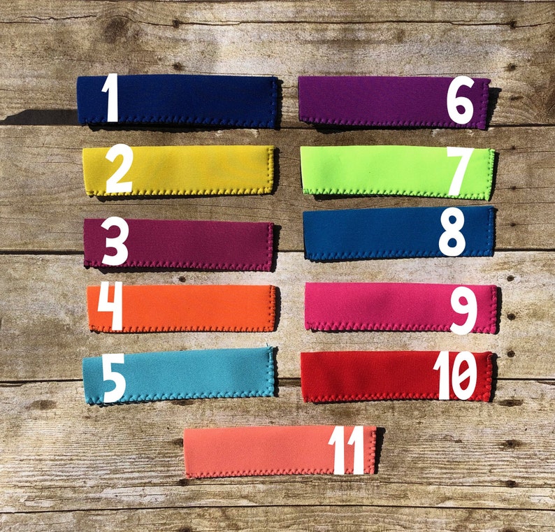 May include: A collection of eleven colorful beverage insulators, each with a different solid color. The insulators are numbered 1 through 11, with colors including navy blue, yellow, purple, orange, teal, and red.