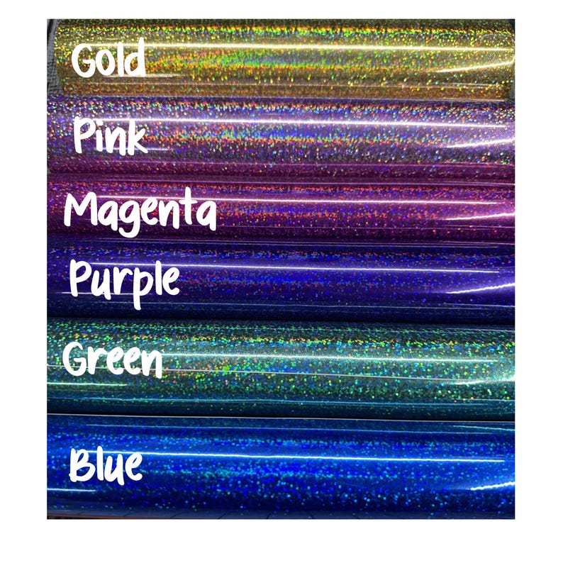 May include: Six horizontal rolls of holographic craft vinyl arranged in a stack. The colours from top to bottom are labelled with white text as Gold, Pink, Magenta, Purple, Green, and Blue. Each roll features a reflective, glittery surface.