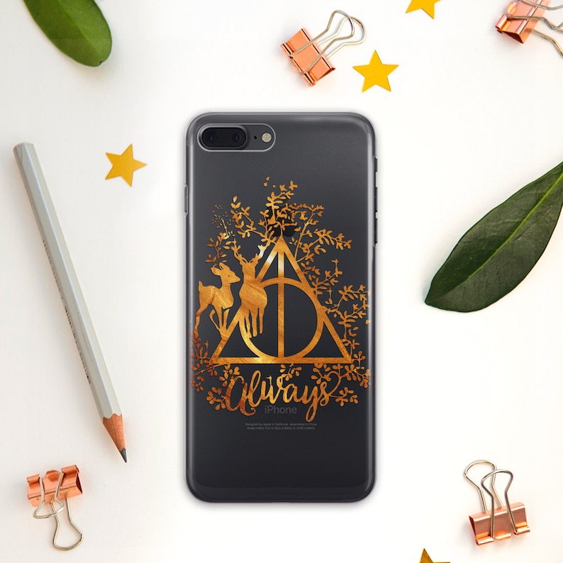 May include: A black iPhone case with a gold metallic design featuring the Deathly Hallows symbol, two deer, and the word "Always".