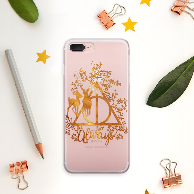 May include: A gold iPhone case with a floral design and the Hogwarts crest. The crest is surrounded by a deer and the word "Always" is written below it.