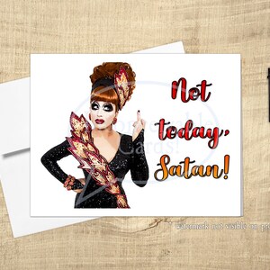 May include: A greeting card featuring a drag queen with red hair and a red and gold costume. The text on the card reads "Not today, Satan!"