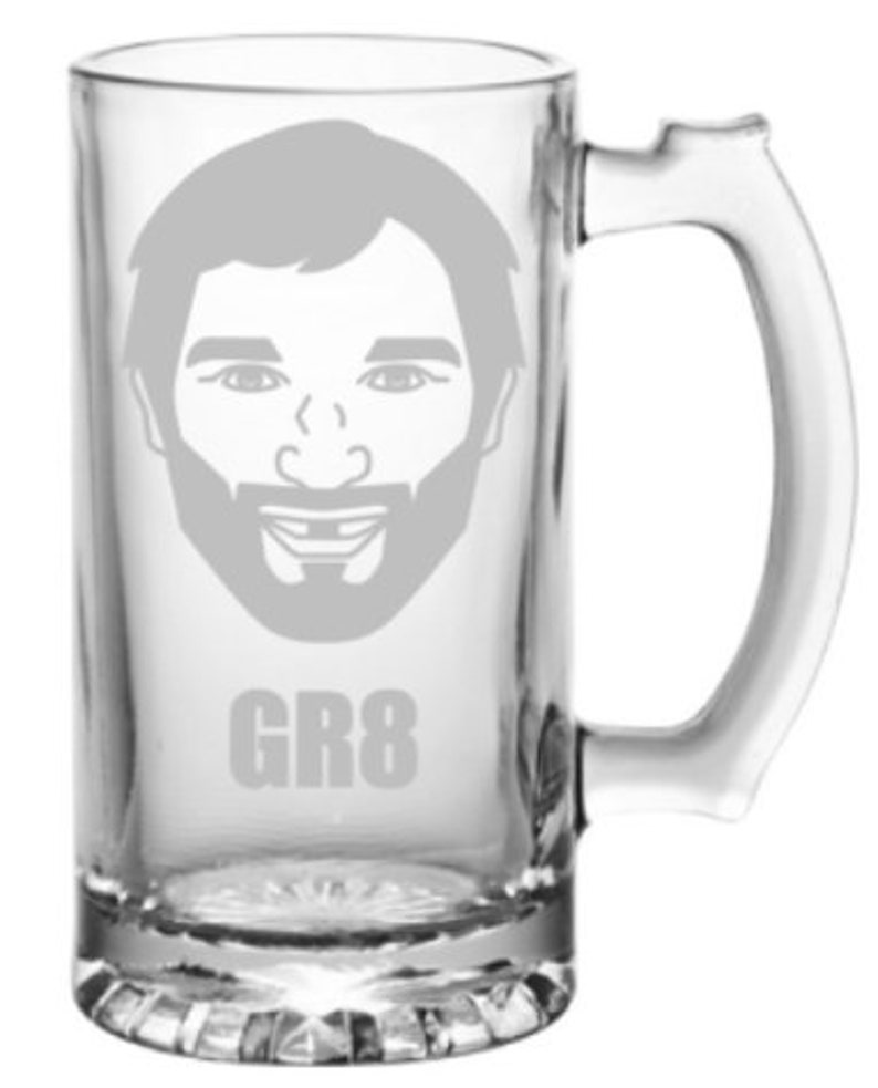 May include: A clear glass beer stein with a personalized design. The design features a cartoon face with a beard and the text "GR8".