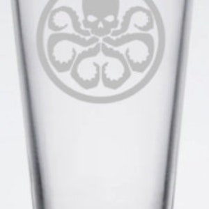 May include: A clear glass pint glass with a white etched design of the Hydra logo from the Marvel Cinematic Universe. The logo features a skull with tentacles.