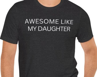 May include: A dark heather grey t-shirt with the text "AWESOME LIKE MY DAUGHTER" printed in white.