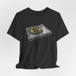 May include: A dark grey t-shirt with a graphic of a silver record player with a gold Bitcoin coin on the turntable.