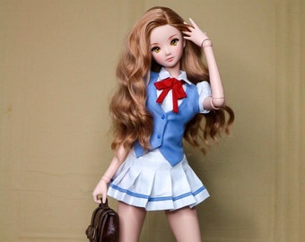 May include: A doll wearing a blue and white school uniform with a red bow tie, holding a brown leather satchel. The doll has long brown hair and is wearing grey knee-high socks and brown boots.