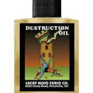 May include: A glass bottle with a black cap and a yellow label that reads "Destruction Oil" with a cartoon image of a tower being destroyed by a lightning bolt. The label also includes the text "Lucky Mojo Curio Co. 4613 Cortesy Road, San Francisco, Cal."
