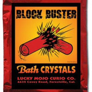 May include: Red and yellow packaging for Block Buster bath crystals. The packaging features a cartoon image of a red dynamite stick exploding. The text on the packaging reads "Block Buster Bath Crystals" and "Lucky Mojo Curio Co. 6623 Cavey Road, Forestville, Cal."