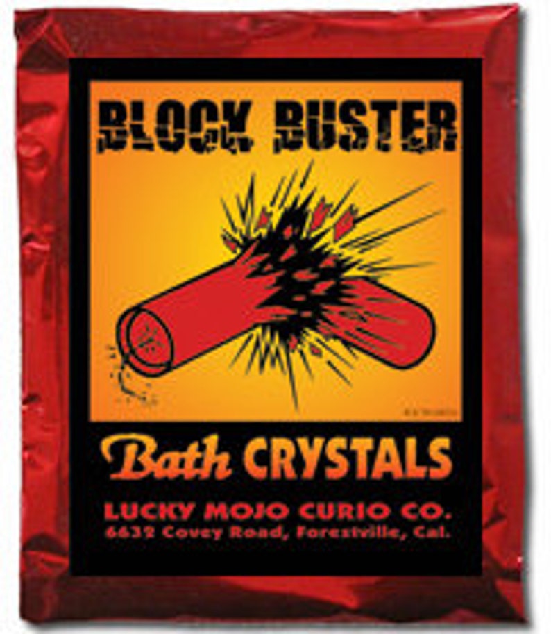 May include: Red and yellow packaging for Block Buster bath crystals. The packaging features a cartoon image of a red dynamite stick exploding. The text on the packaging reads "Block Buster Bath Crystals" and "Lucky Mojo Curio Co. 6623 Cavey Road, Forestville, Cal."