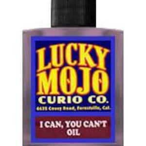 May include: A small blue glass bottle with a black cap. The bottle has a white label with the text "Lucky Mojo Curio Co." and "I Can, You Can't Oil".