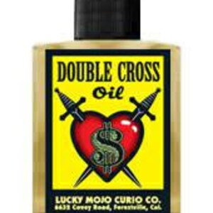 May include: A yellow and red bottle of Double Cross Oil with a black cap. The bottle features a graphic of a heart with two swords and a dollar sign inside. The label also includes the text "Lucky Mojo Curio Co. 8433 Corey Road, Perris, Cal."