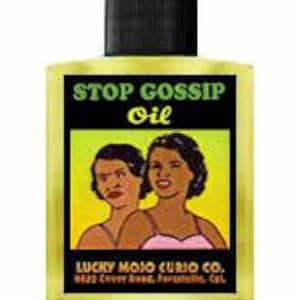 May include: A yellow glass bottle with a black cap and a label that reads "STOP GOSSIP Oil" with a cartoon image of two women. The label also includes the text "LUCKY MOJO CURIO CO. 623 Crown Blvd.,  Pasadena, Cal."