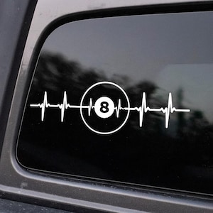 May include: White vinyl decal featuring a heartbeat design with a pool ball graphic. The pool ball is inside a circle with the number 8 in the center. The decal is designed to be applied to a car window or similar surface.