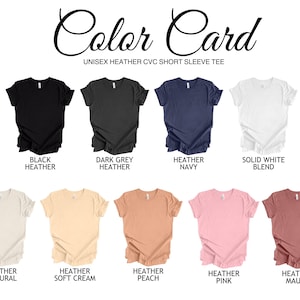 May include: Color card showing ten different colors of unisex short sleeve t-shirts. The colors are: Black Heather, Dark Grey Heather, Heather Navy, Solid White Blend, Heather Natural, Heather Soft Cream, Heather Peach, Heather Pink, Heather Mauve.