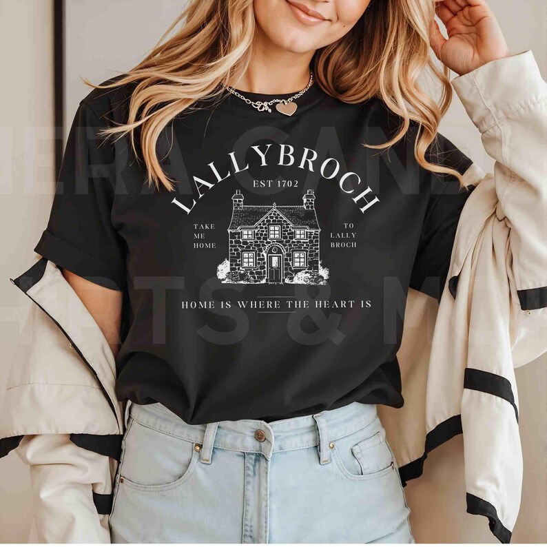 May include: Black t-shirt with a white graphic design featuring a house with the text "Lallybroch Est 1702" and "Take me home to Lallybroch. Home is where the heart is."