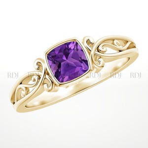 May include: A gold ring featuring a square, deep purple gemstone. The ring has an ornate, swirling design on the sides. The gemstone is set in a square bezel, and the band is a simple, polished gold.