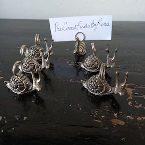 May include: A set of three ceramic mugs with a speckled, matte finish. Each mug is a different colour: light blue, cream, and grey. The mugs have a simple, modern design and a comfortable handle.