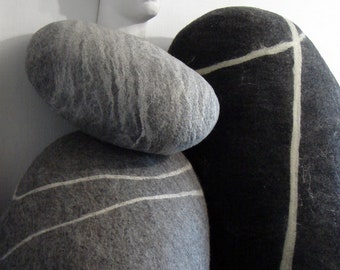 Companions from felted pillows different shades and sizes interestingly complement each other.Seamless pillows and poufs imitating sea rocks