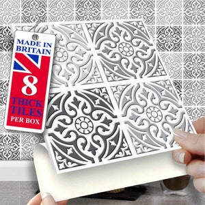 May include: Eight grey and white patterned peel and stick tile stickers. The tiles have a decorative design with a floral motif. The tiles are made in Britain.