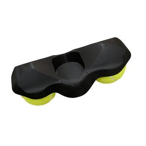 May include: A black, elongated, molded plastic holder featuring a central circular indentation and two circular openings on the underside, each containing a bright yellow tennis ball with white seams, designed for mounting on a flat surface.