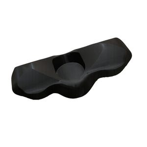 May include: A black, solid, elongated object with a smooth, contoured surface featuring a central circular indentation. The piece has an irregular, organic shape with rounded edges and a glossy finish, appearing as a singular, molded component.