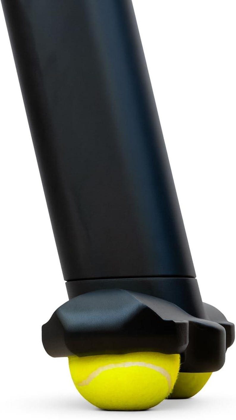 May include: A matte black furniture leg attachment featuring a molded, claw-like base that securely grips a bright yellow tennis ball. The cylindrical leg extends upward, while the base provides a stable, cushioned contact point for floor protection.