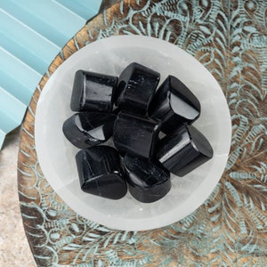 May include: A handmade, wooden serving tray with a natural finish. The tray features a rectangular shape with rounded corners and two carved handles. The wood grain is visible, adding to its rustic charm. Perfect for serving food or displaying items.