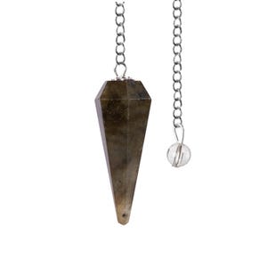 May include: A faceted, elongated pendulum made of a dark, speckled stone, suspended by a silver-colored chain. A small, clear crystal bead hangs from a separate chain. The pendulum is designed for divination and spiritual practices.