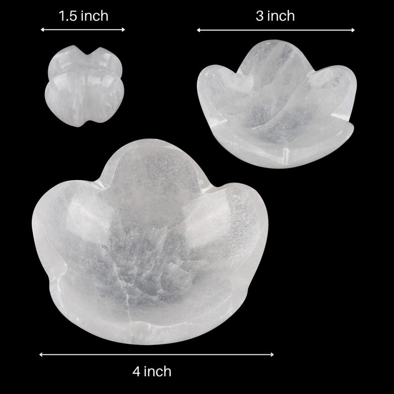 May include: Two white crystal flower-shaped bowls, one measuring 3 inches wide and the other 4 inches wide. A smaller white crystal flower-shaped object measuring 1.5 inches wide is also shown.
